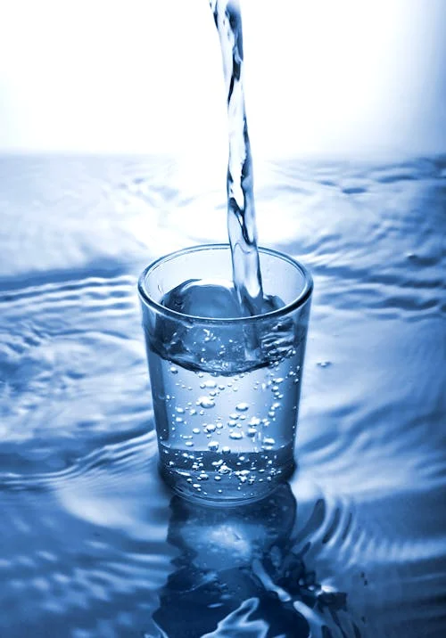 Pouring water into a glass